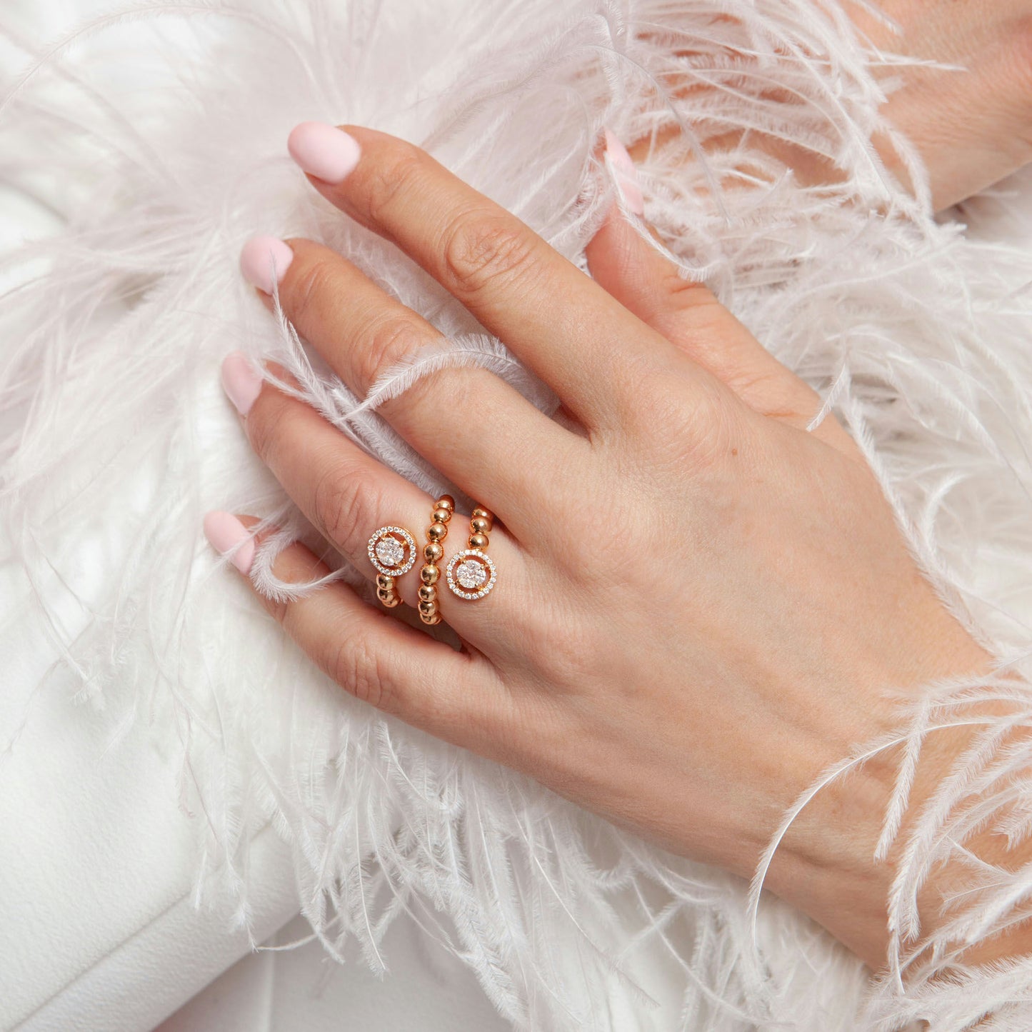 18K pink gold ring featuring 0.74 ct natural diamonds and a spiral design with two circular diamond halos.