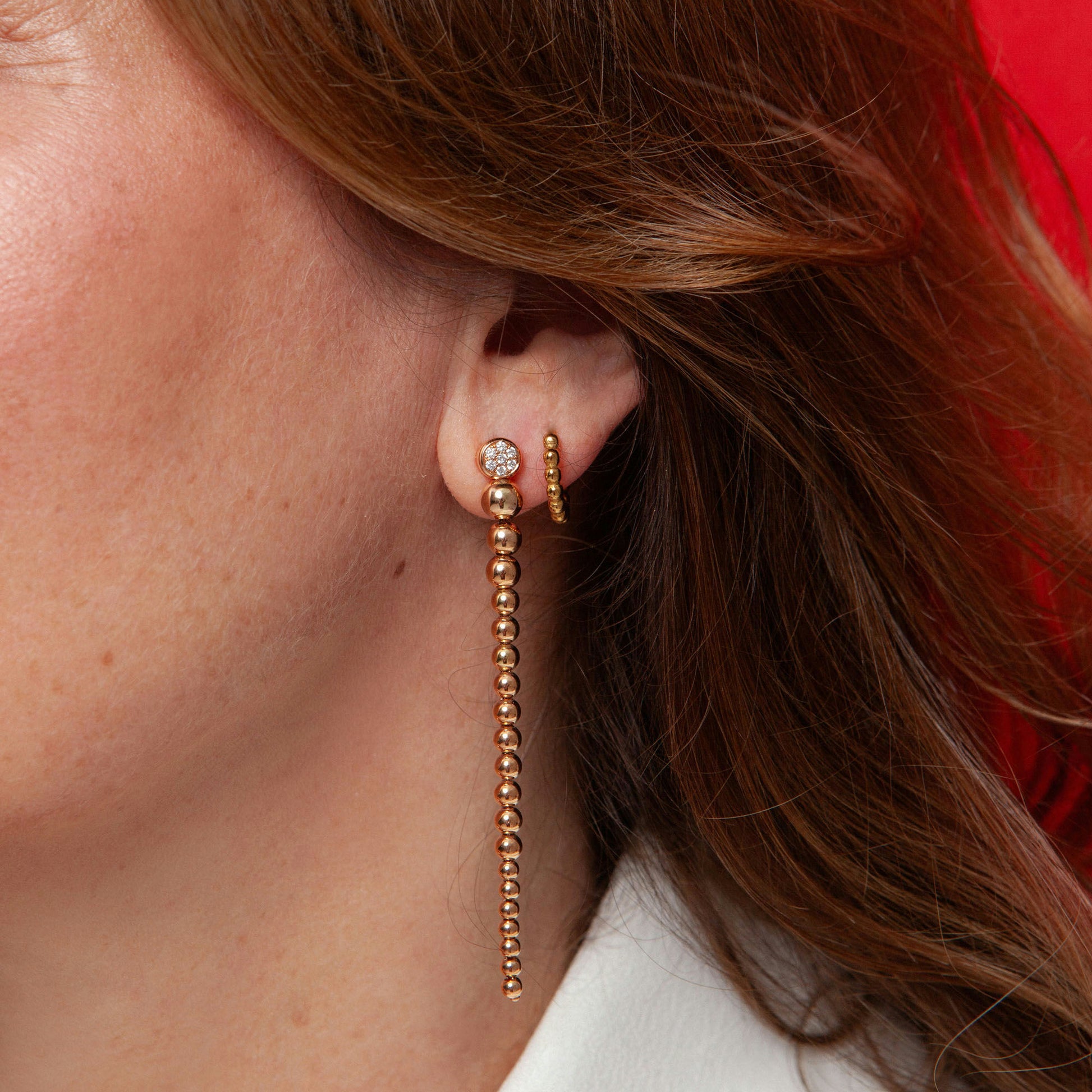Long drop earrings in 18K pink gold featuring 14 natural diamonds totaling 0.20 ct and a beaded design.