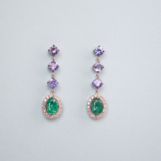 18K White Gold drop earrings featuring 1.51 ct Natural Emeralds and 1.65 ct Natural Tanzanites with diamond accents.