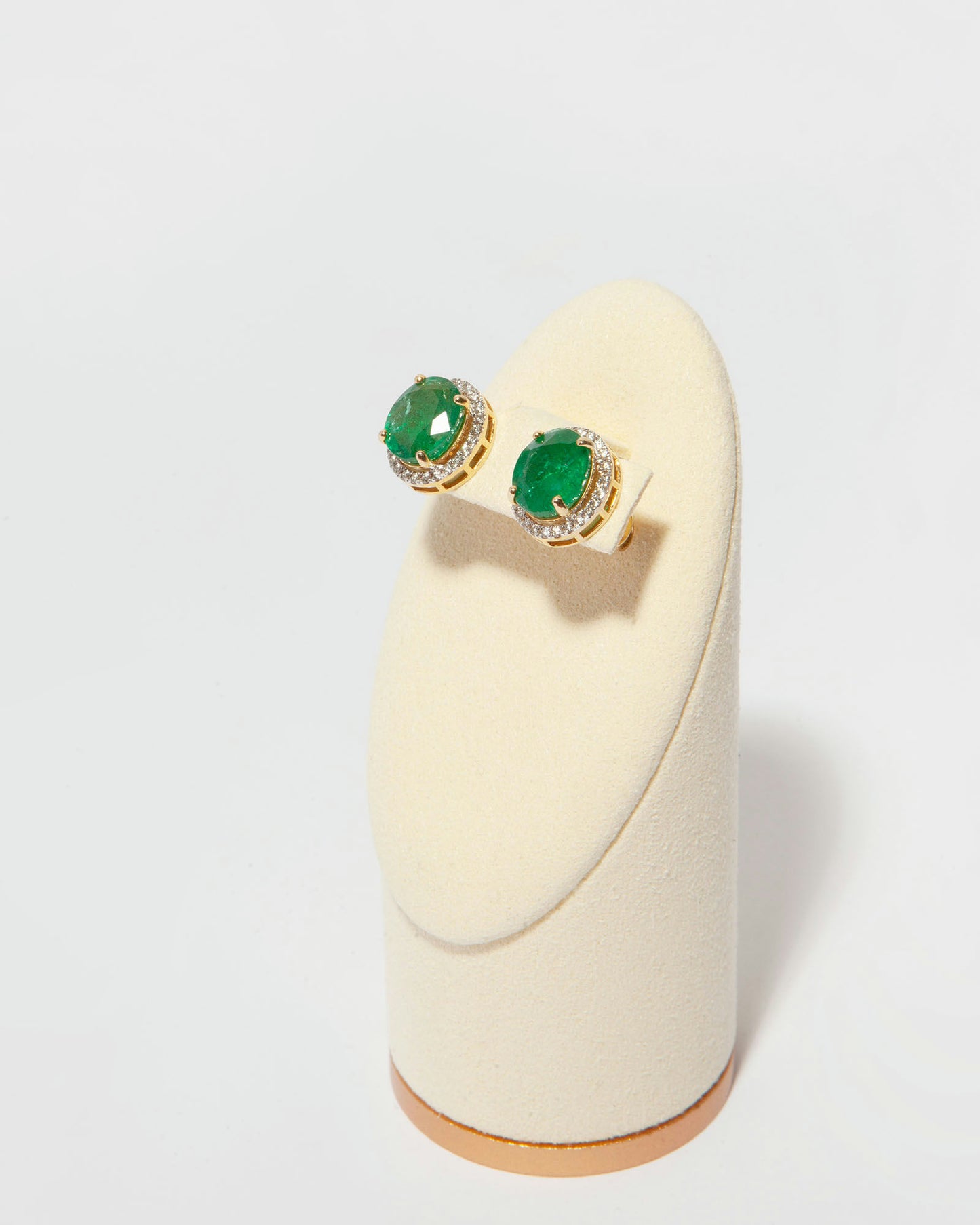 Stud earrings in 14K yellow gold featuring two oval mixed-cut natural emeralds (6.60 ct) and 51 natural diamonds (0.40 ct).