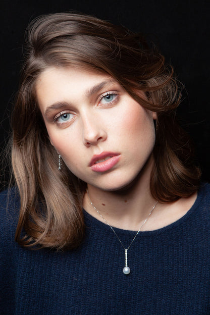 NOVI Jewelry floral-inspired pendant with blue-toned gemstones, elegant luxury gemstone flower design.