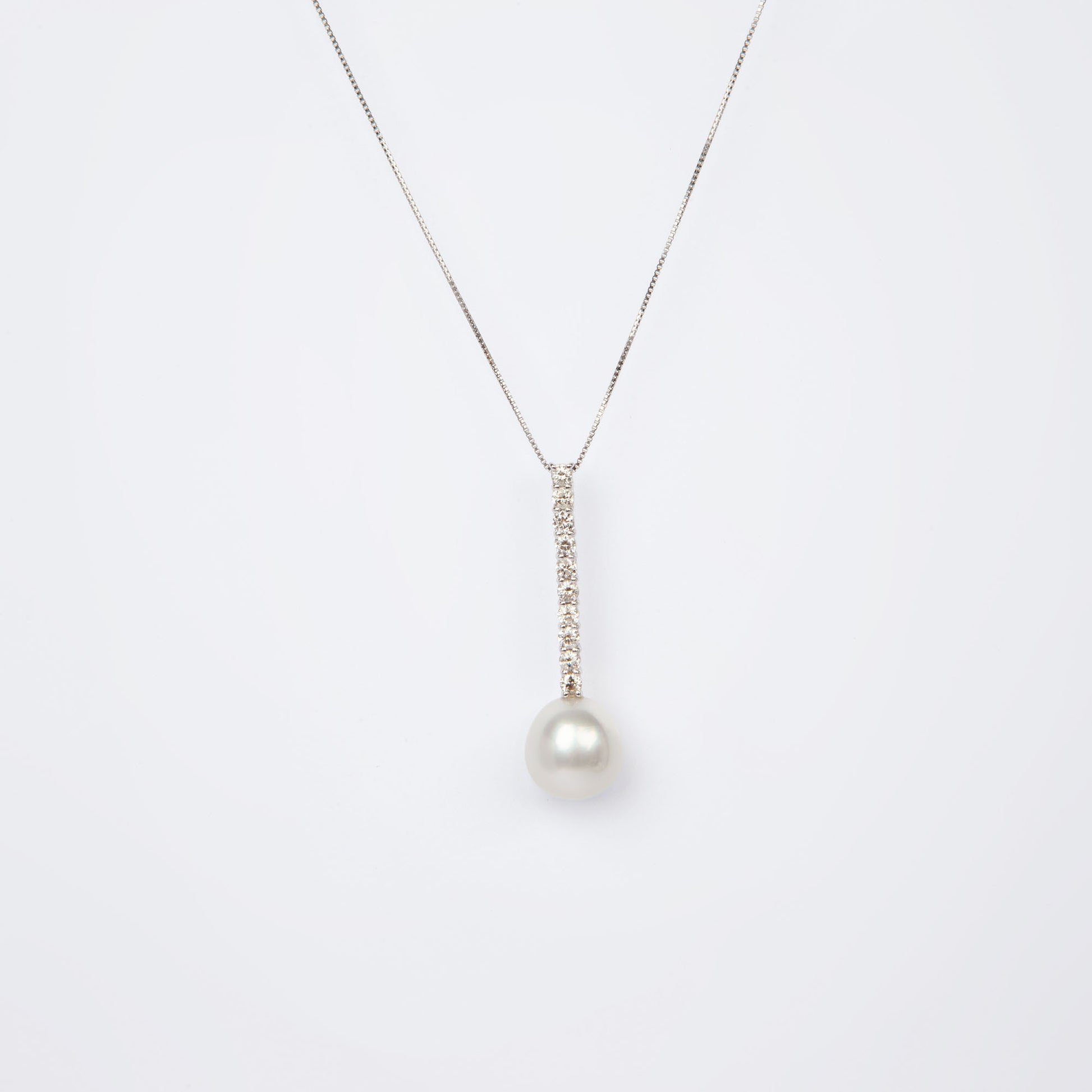 NOVI Jewelry floral-inspired pendant with blue-toned gemstones, elegant luxury gemstone flower design.