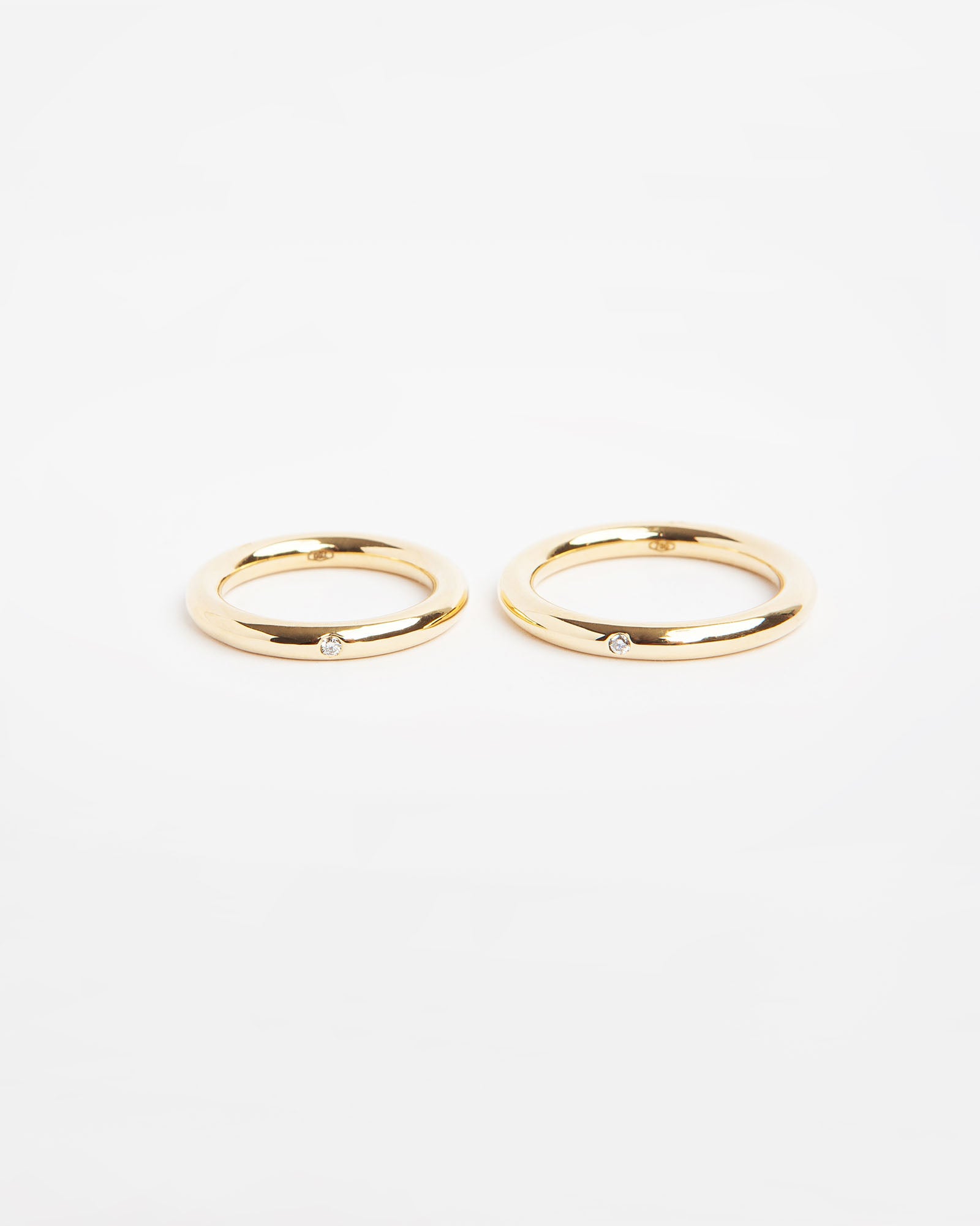 NOVI Jewelry 18K yellow gold wedding rings with 0.015 ct natural diamonds, elegant matching diamond ring pair.