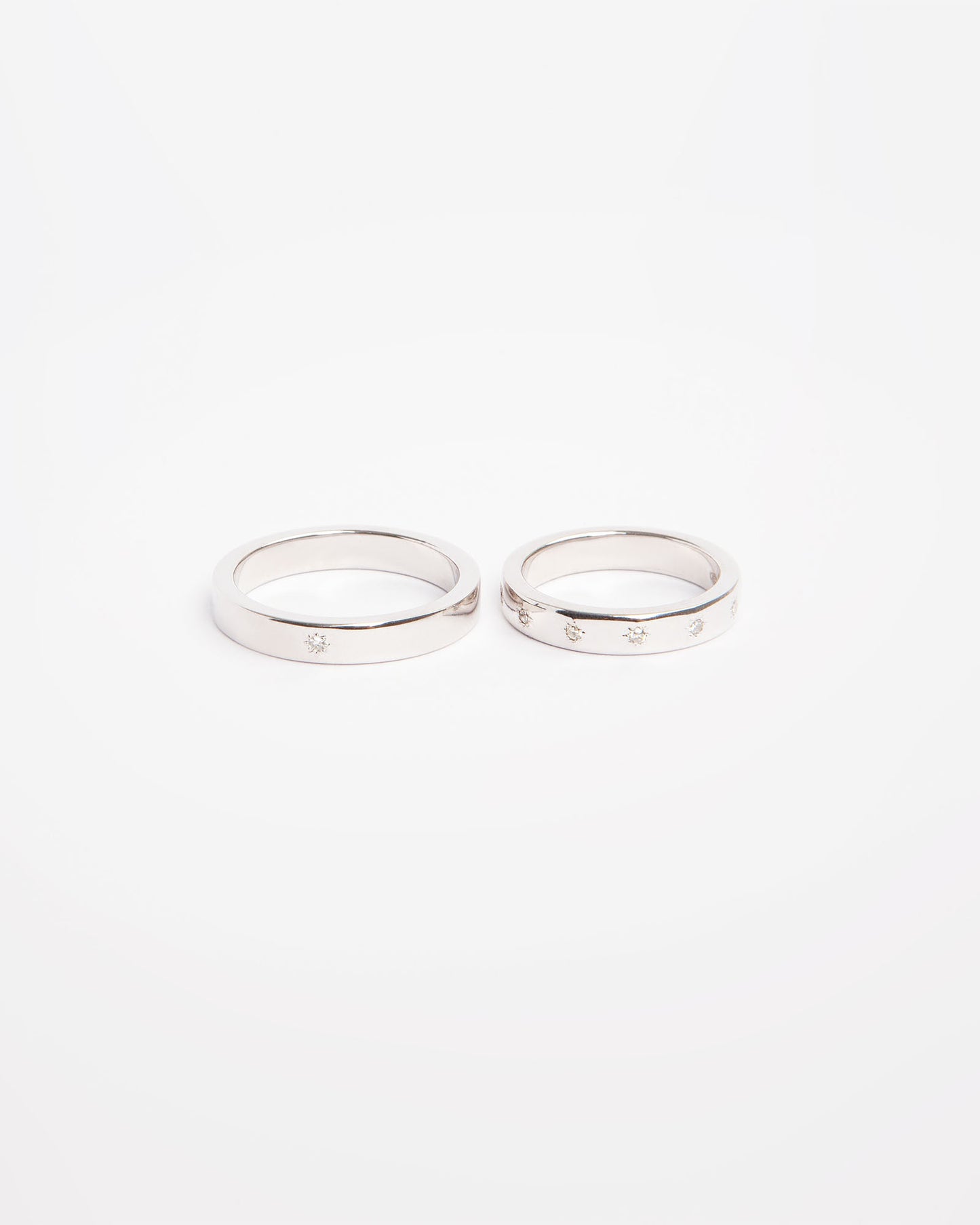 NOVI Jewelry 18K white gold wedding rings set with 0.132 ct natural diamonds, elegant matching diamond ring pair.