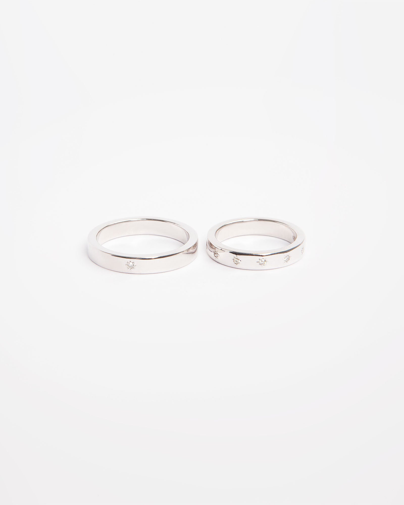 NOVI Jewelry 18K white gold wedding rings set with 0.132 ct natural diamonds, elegant matching diamond ring pair.