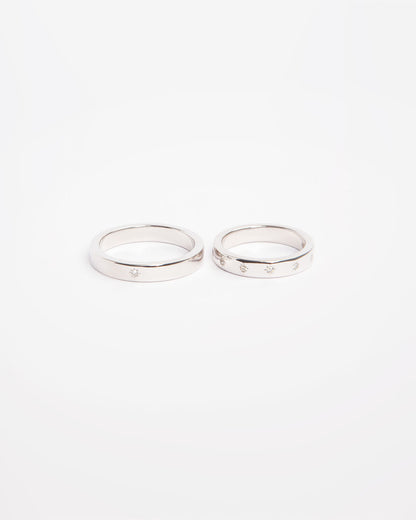 NOVI Jewelry 18K white gold wedding rings set with 0.132 ct natural diamonds, elegant matching diamond ring pair.