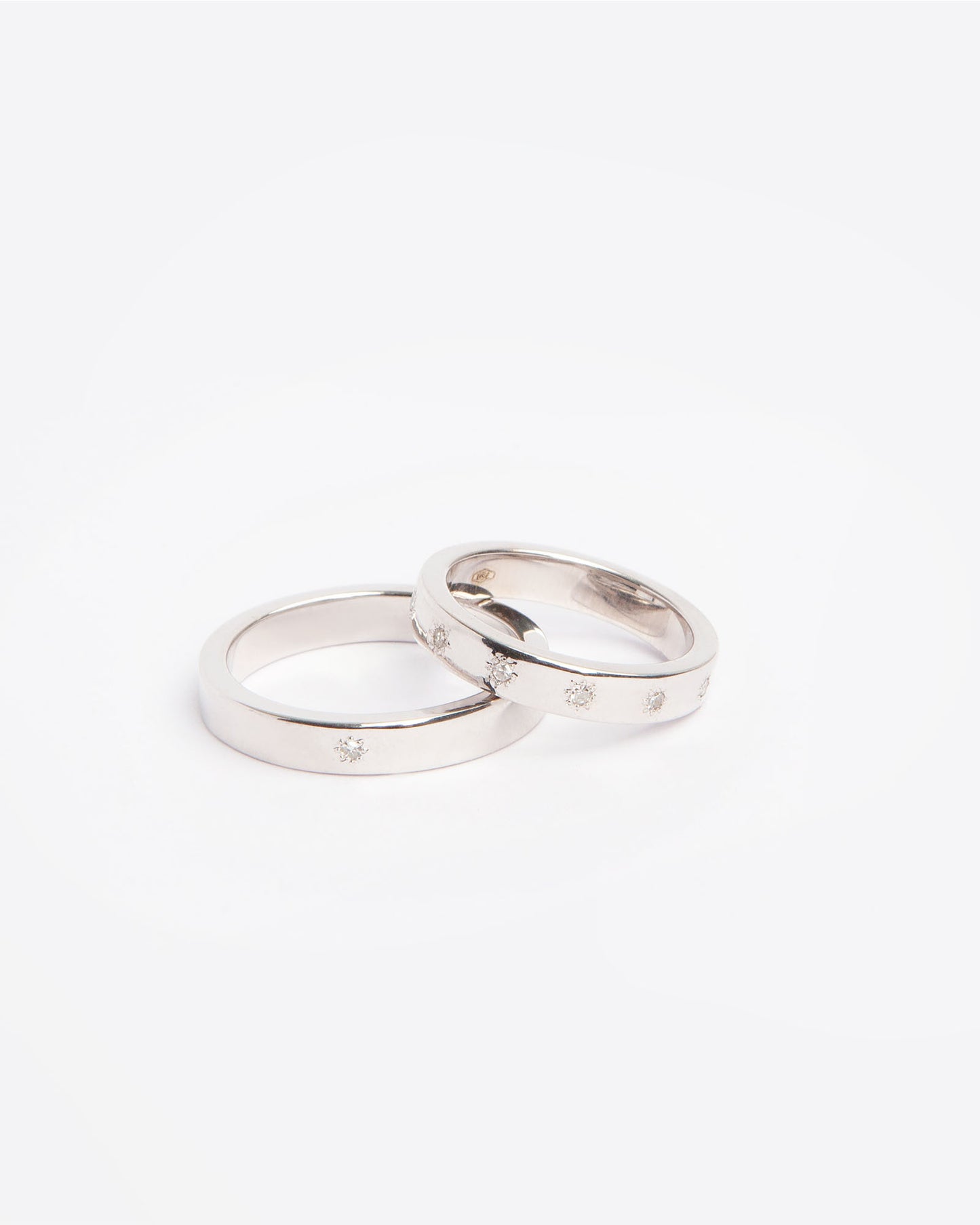 NOVI Jewelry 18K white gold wedding rings set with 0.132 ct natural diamonds, elegant matching diamond ring pair.