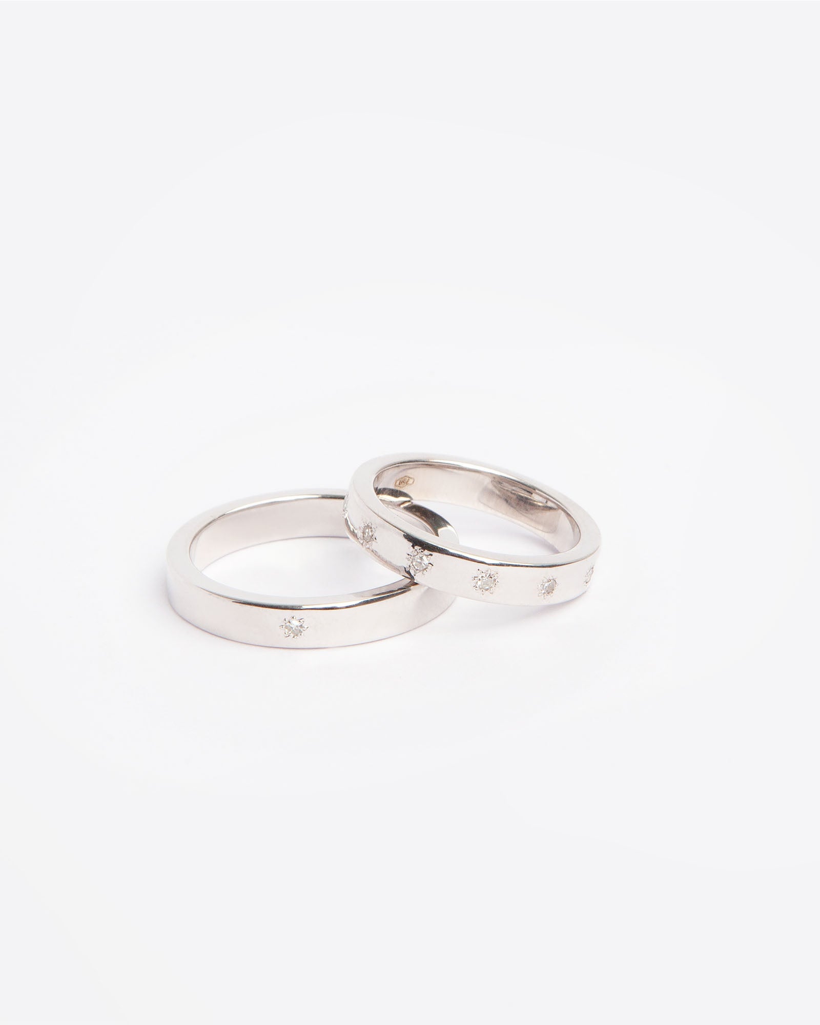 NOVI Jewelry 18K white gold wedding rings set with 0.132 ct natural diamonds, elegant matching diamond ring pair.