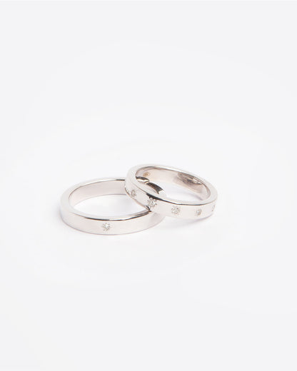 NOVI Jewelry 18K white gold wedding rings set with 0.132 ct natural diamonds, elegant matching diamond ring pair.