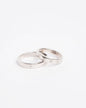 NOVI Jewelry 18K white gold wedding rings set with 0.132 ct natural diamonds, elegant matching diamond ring pair.