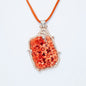 Pendant in gold featuring natural coral 81.82 ct and 231 natural diamonds 1.85 ct with ruby accent 0.12 ct.