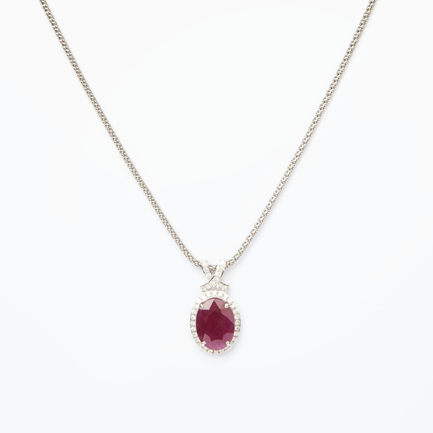 14-karat white gold pendant featuring a 6.75ct natural ruby and 40 diamonds totaling 0.51ct, certified by IGI.
