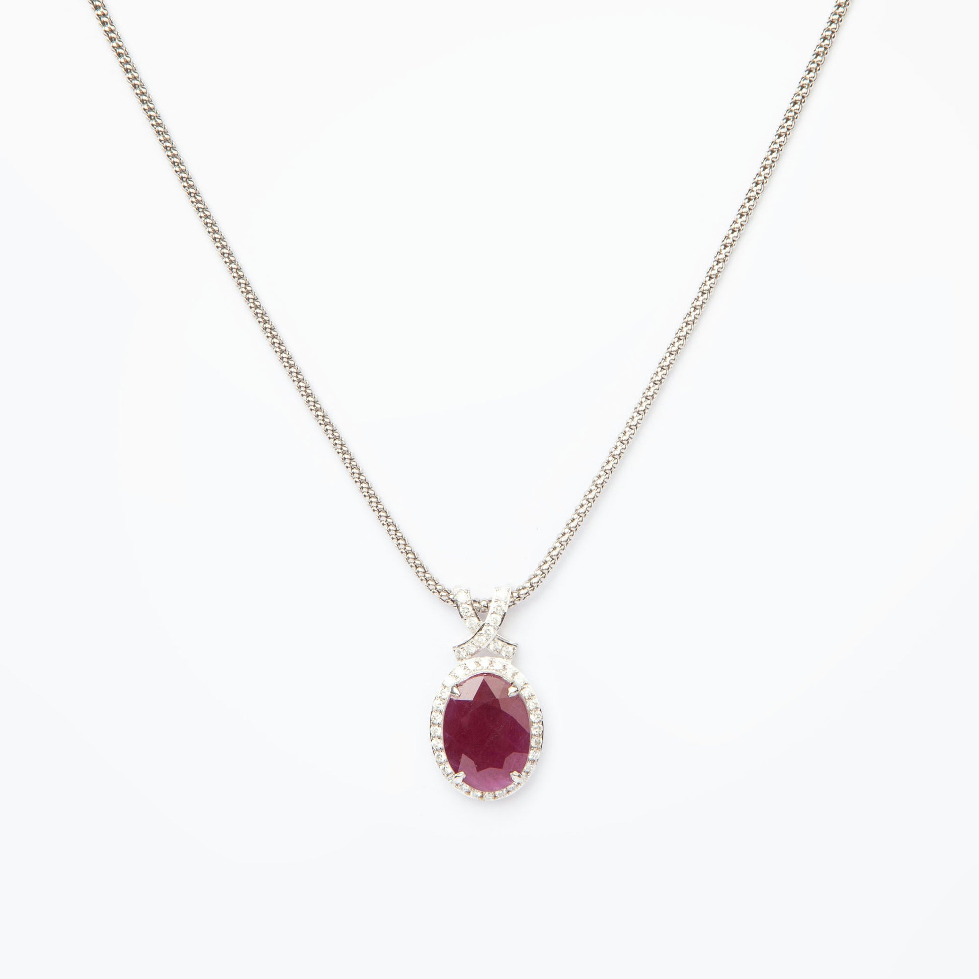 14-karat white gold pendant featuring a 6.75ct natural ruby and 40 diamonds totaling 0.51ct, certified by IGI.