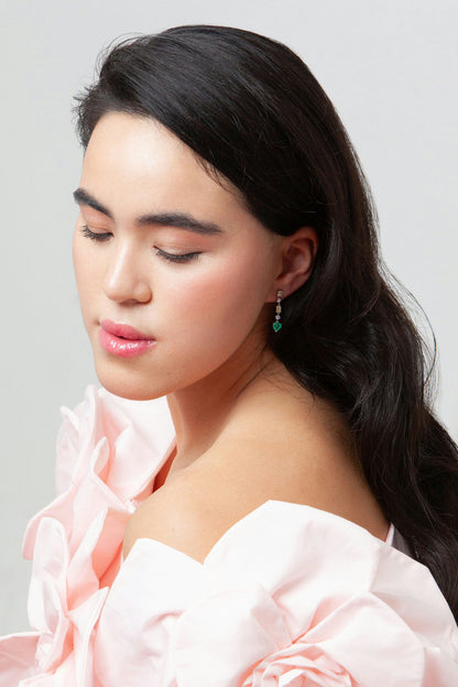 Drop earrings in 18K white gold featuring 1.669 ct heart-cut emeralds and 1.674 ct total diamonds and color sapphires.