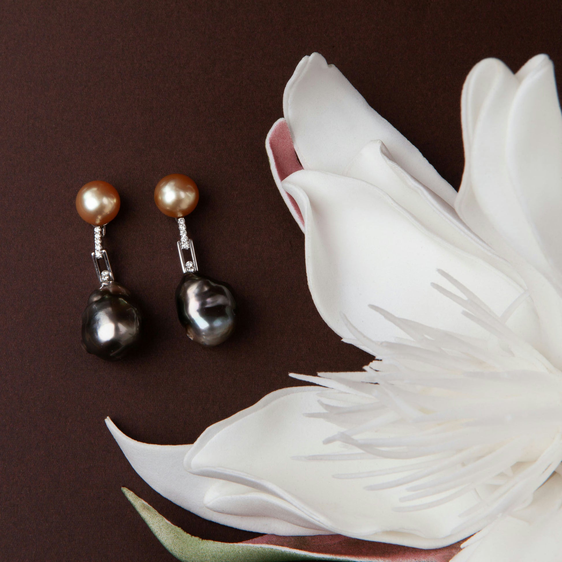 Earrings in 18K white gold featuring 10 mm South Sea pearls, 15 mm black baroque pearls, and 10 diamonds totaling 0.21 ct.