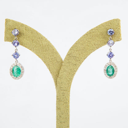 18K White Gold drop earrings featuring 1.51 ct Natural Emeralds and 1.65 ct Natural Tanzanites with diamond accents.