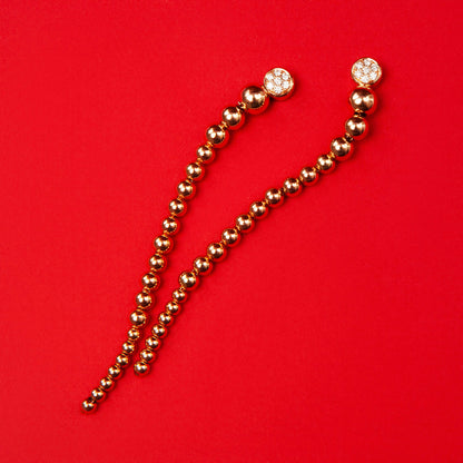 Long drop earrings in 18K pink gold featuring 14 natural diamonds totaling 0.20 ct and a beaded design.