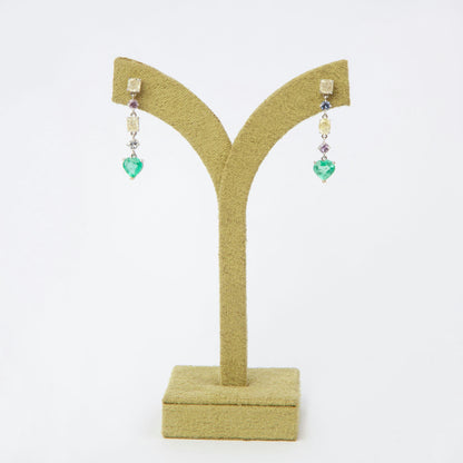 Drop earrings in 18K white gold featuring 1.669 ct heart-cut emeralds and 1.674 ct total diamonds and color sapphires.